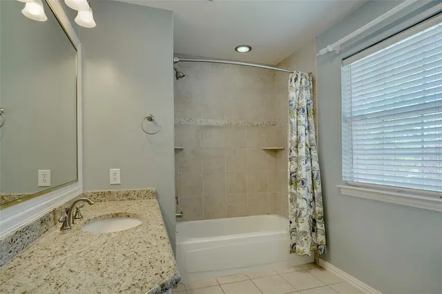 a bathroom with a bathtub and shower