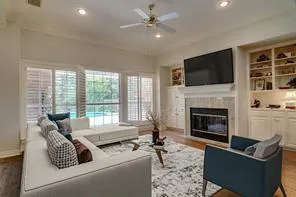 a living room with furniture a flat screen tv and a fireplace