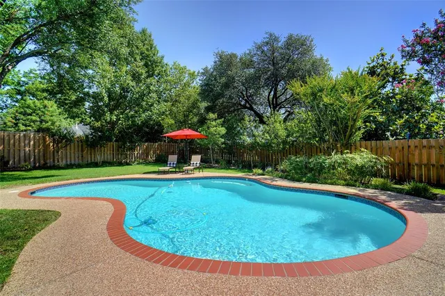 a view of a swimming pool with a yard