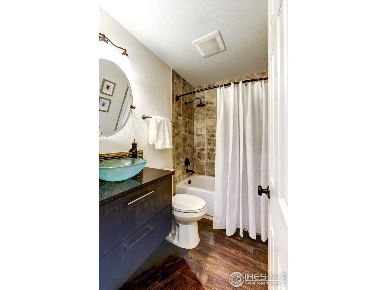 3025 Broadway, Unit 8 Boulder, CO 80304 - Photo 8 of 16 a bathroom with a toilet and a shower curtain