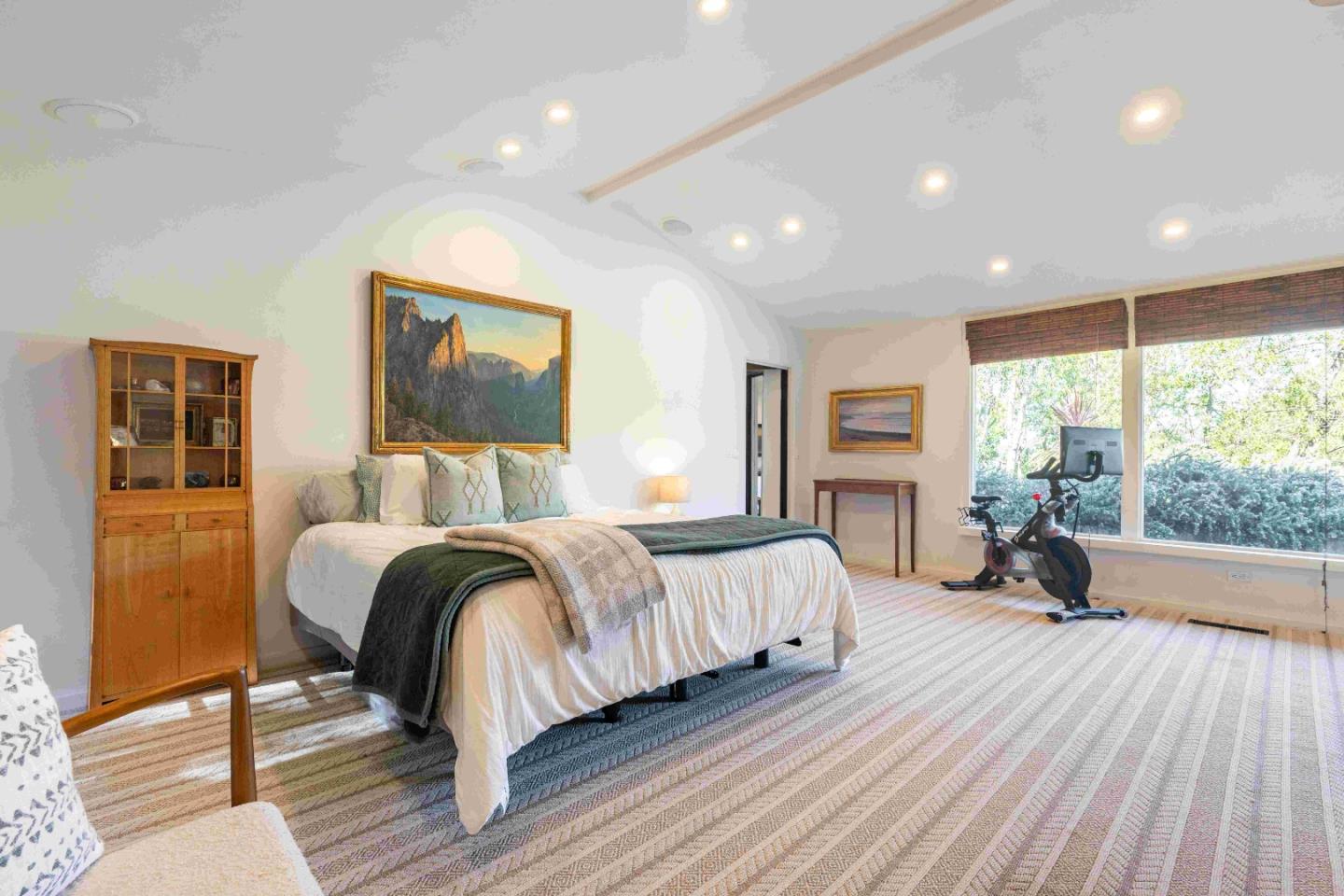 60 Los Ositos Road Carmel Valley, CA 93924 - Photo 13 of 47 a spacious bedroom with a bed and wooden floor