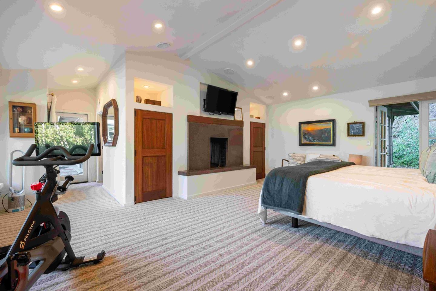 60 Los Ositos Road Carmel Valley, CA 93924 - Photo 14 of 47 a spacious bedroom with a bed and a flat screen tv