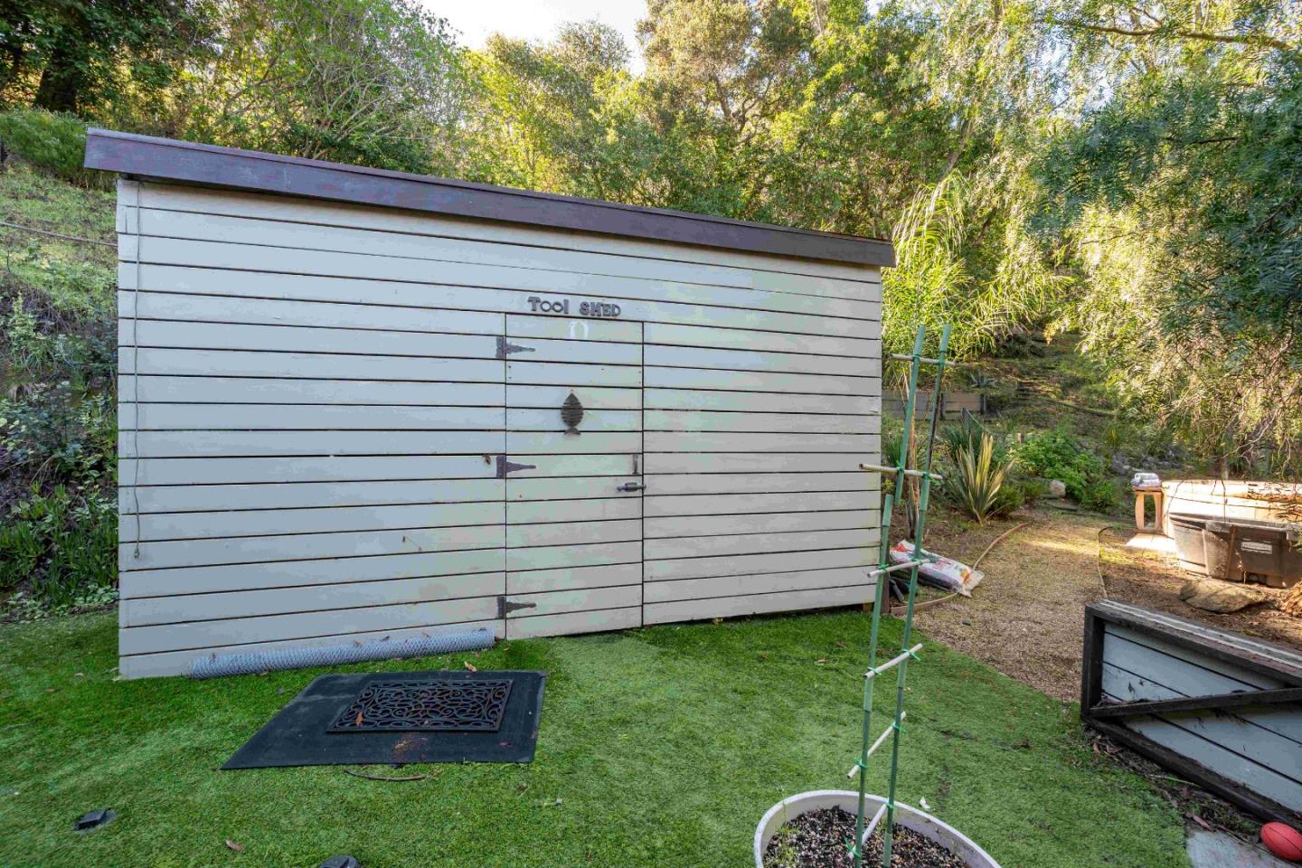 60 Los Ositos Road Carmel Valley, CA 93924 - Photo 38 of 47 a view of a backyard with plants and a large tree