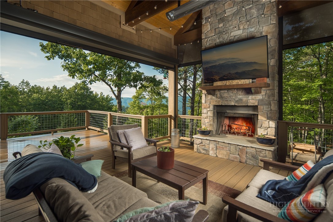 115 Passionflower Trail Boone, NC 28607 - Photo 13 of 50 a outdoor living space with furniture and a fireplace