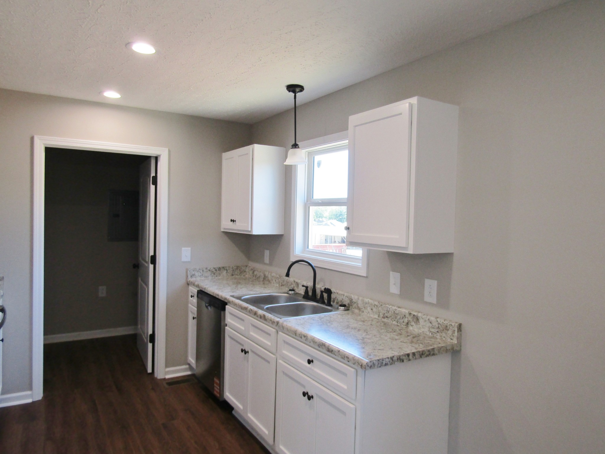 460 Crescent Factory Road Lawrenceburg, TN 38464 - Photo 7 of 13 a kitchen with a sink stove and cabinets