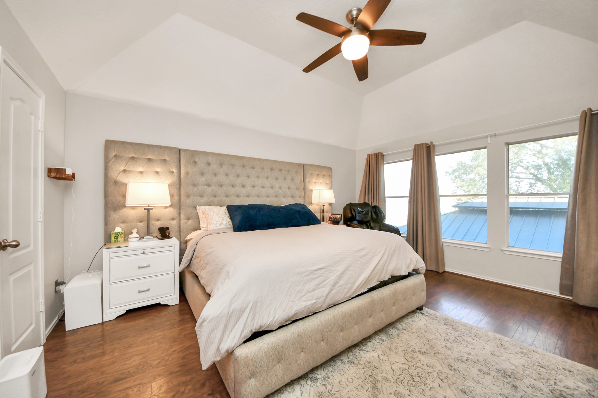 3515 Shadowside Court Houston, TX 77082 - Photo 16 of 31 a bedroom with a large bed and a chandelier fan