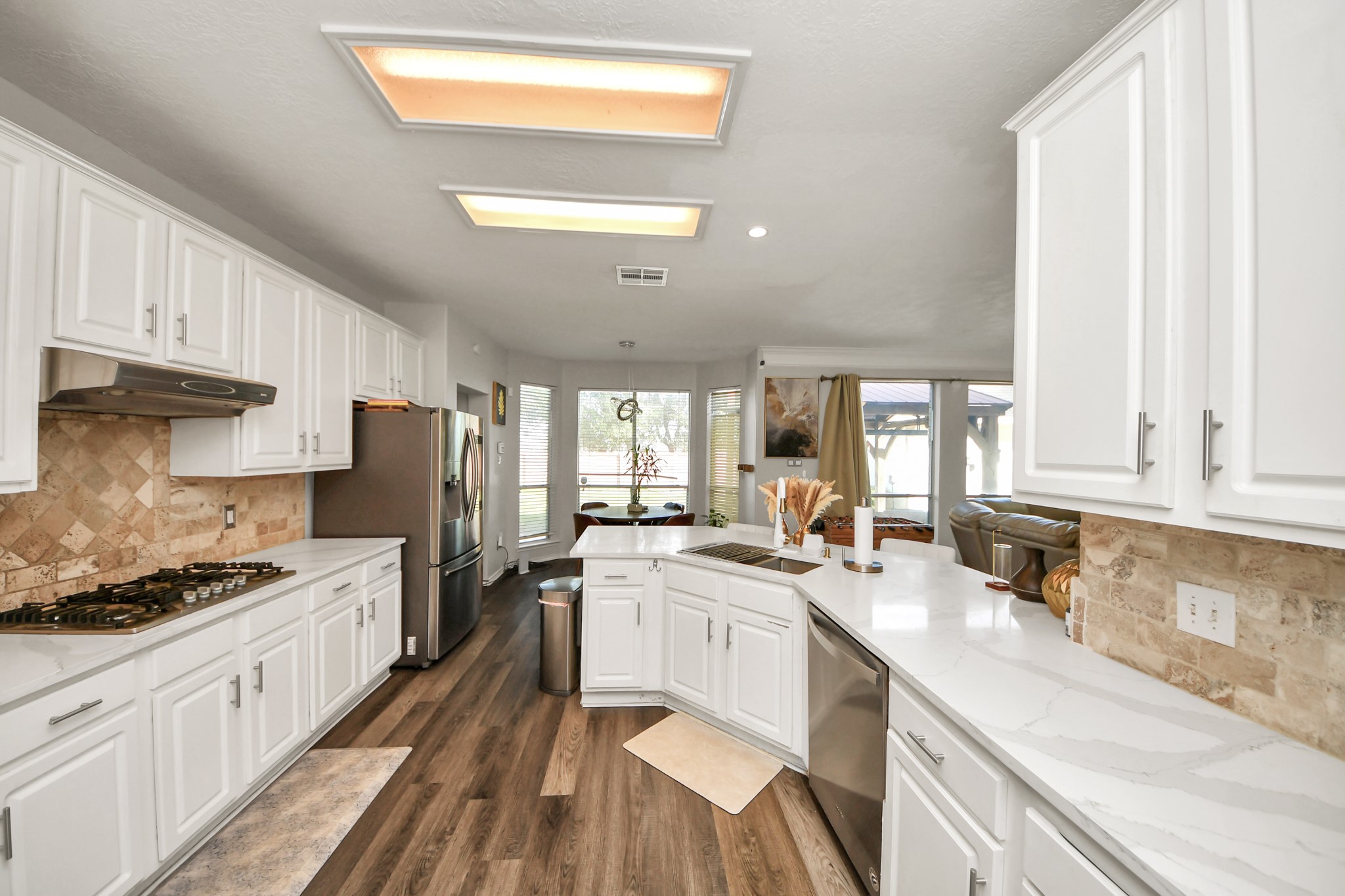 3515 Shadowside Court Houston, TX 77082 - Photo 8 of 31 a kitchen with a sink stainless steel appliances a window and cabinets