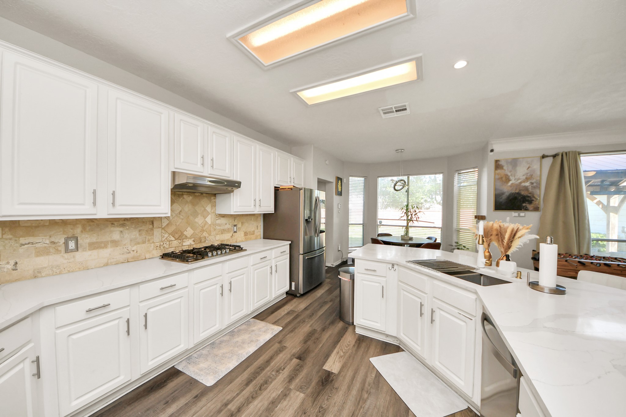 3515 Shadowside Court Houston, TX 77082 - Photo 9 of 31 a kitchen that has a lot of white cabinets and stainless steel appliances