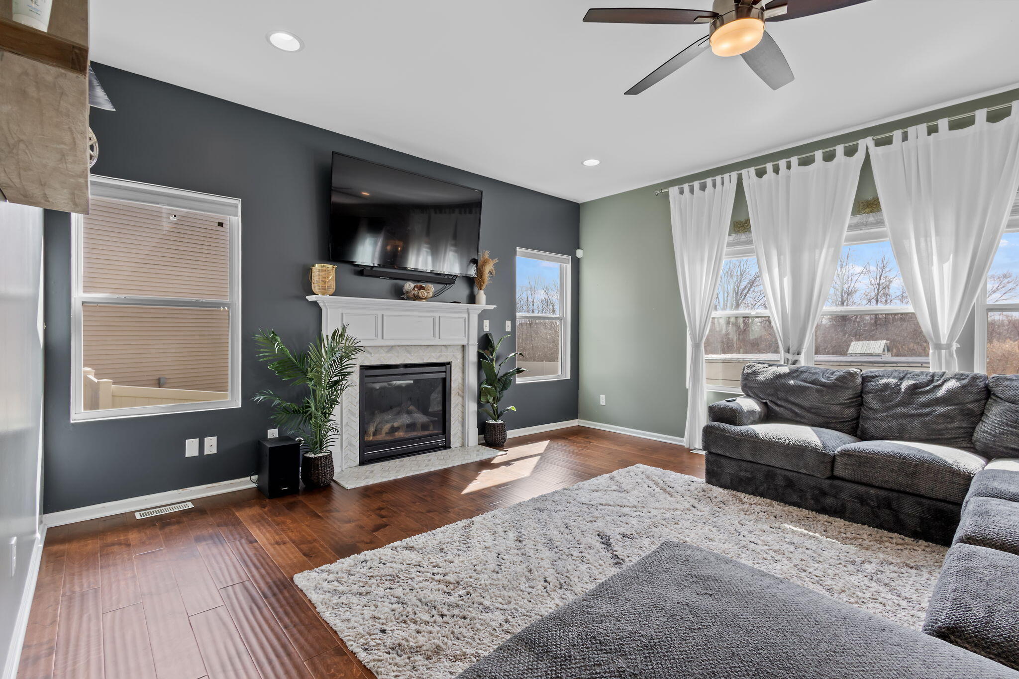 12938 Hayes Street Crown Point, IN 46307 - Photo 3 of 32 a living room with furniture and a fireplace