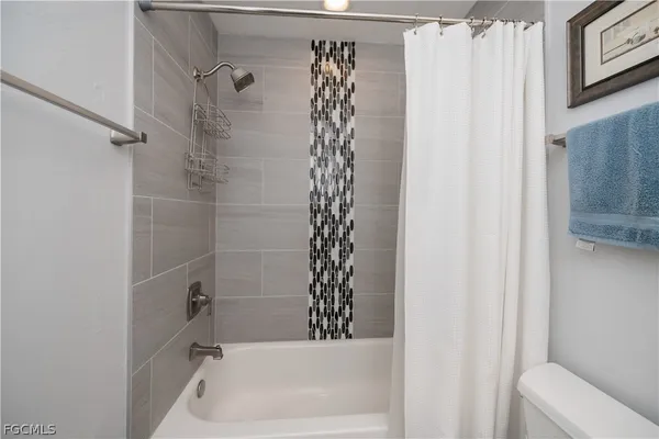 a bathroom with a bathtub and shower