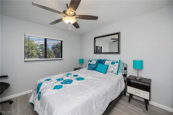 a bedroom with a bed a desk and chair