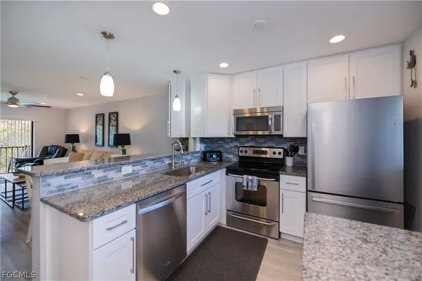 a kitchen with a sink stove and refrigerator