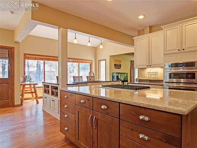 735 Winding Hills Road Monument, CO 80132 - Photo 15 of 42 Island has quart countertop, 6 gas burner cook top and plenty of prep space