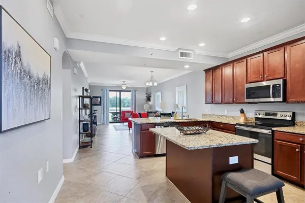 a kitchen with stainless steel appliances granite countertop a sink stove and cabinets