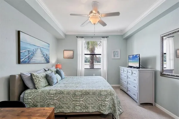 a bedroom with a large bed and a chandelier