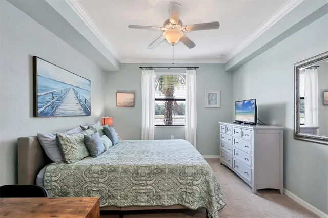 a bedroom with a large bed and a chandelier