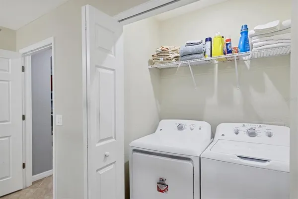 a bathroom with a granite countertop sink vanity mirror bathtub shower and a toilet