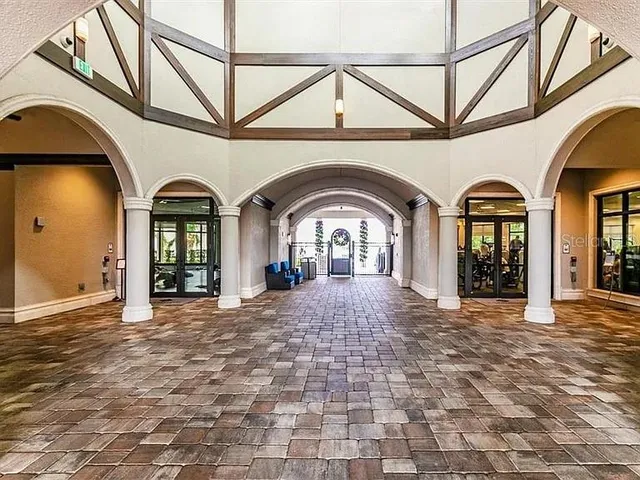 a front view of a house with garden and trees