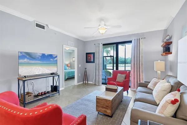 a living room with furniture a flat screen tv and a fireplace