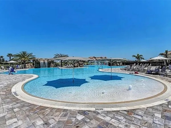 a living room with furniture flat screen tv and a large window