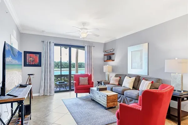 a living room with furniture a table and a large window