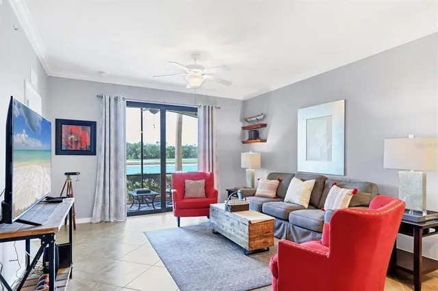 a living room with furniture a table and a large window