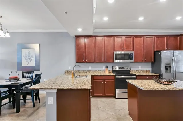 a kitchen with a stove a refrigerator and wooden cabinets