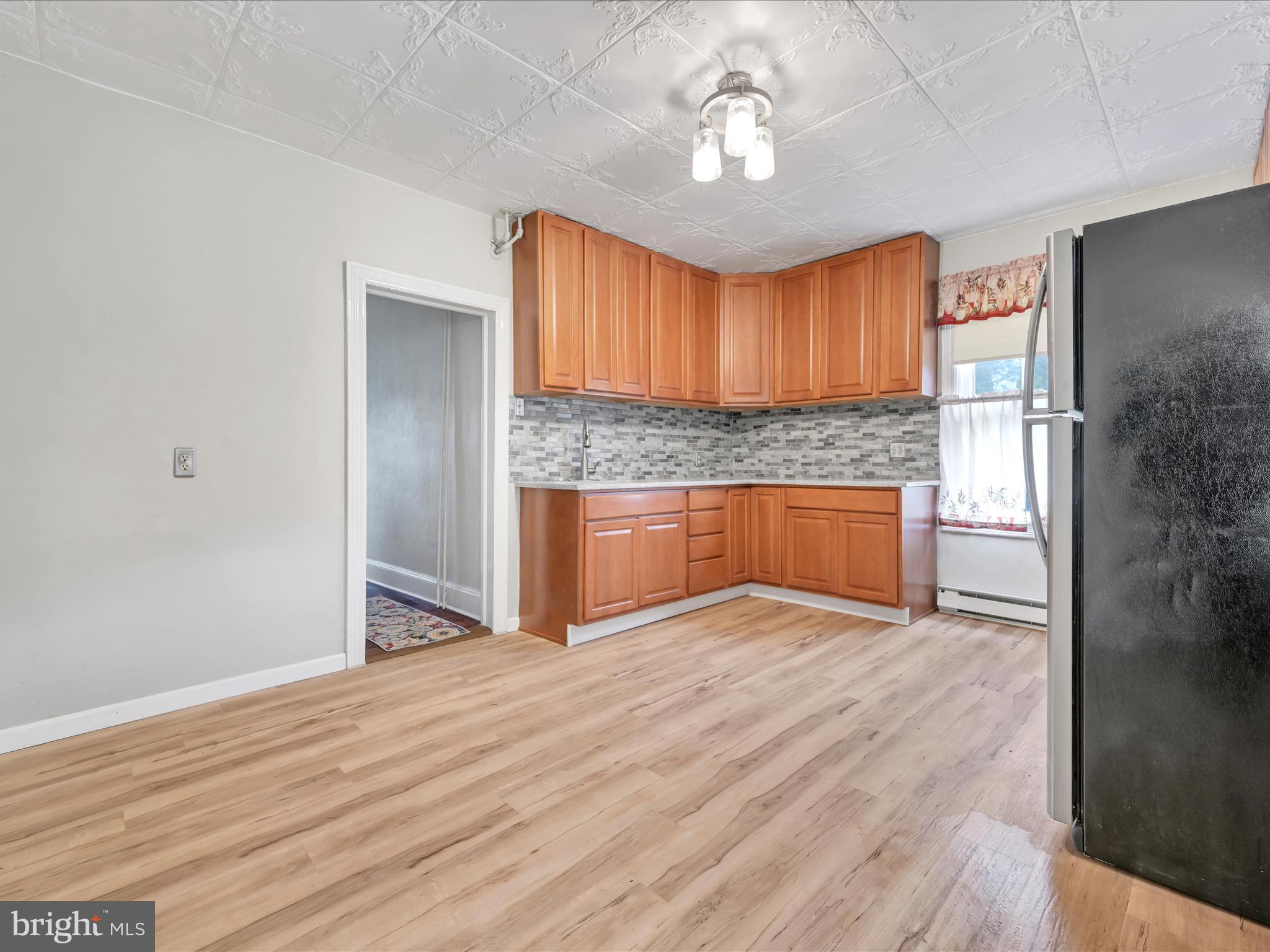 235 Biddle Street Gordon, PA 17921 - Photo 11 of 33 an empty room with wooden floor cabinet and windows