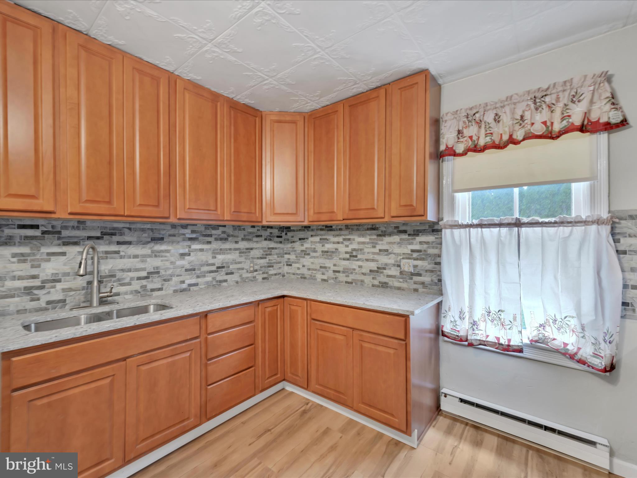 235 Biddle Street Gordon, PA 17921 - Photo 8 of 33 a kitchen with granite countertop wooden cabinets and sink
