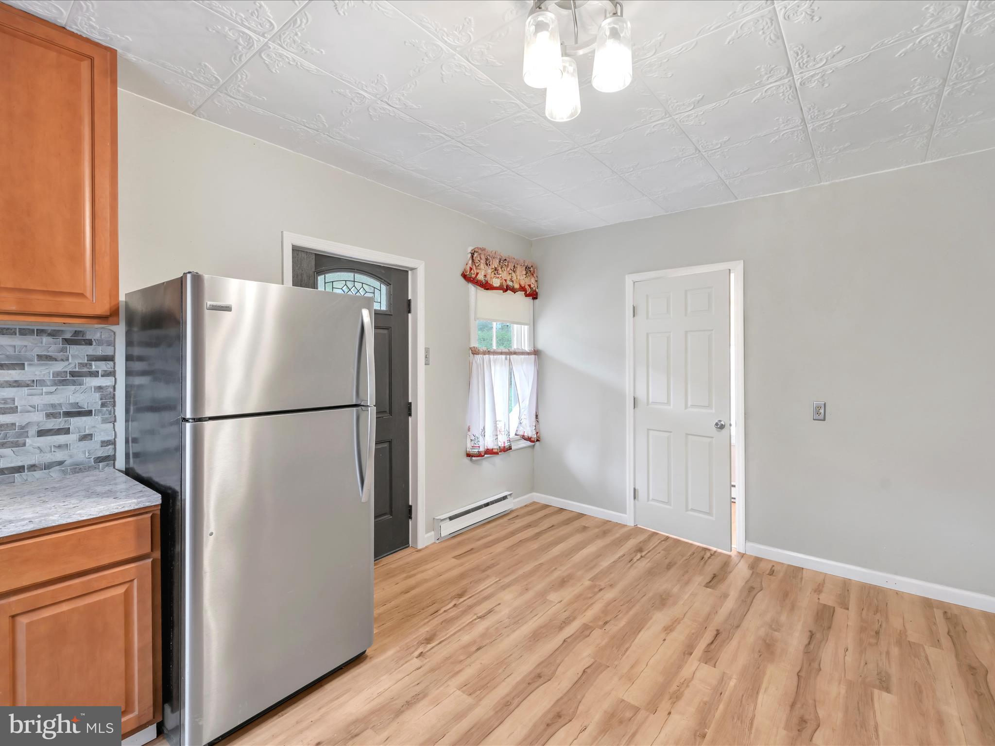 235 Biddle Street Gordon, PA 17921 - Photo 10 of 33 a kitchen with a refrigerator a stove cabinets and wooden floor