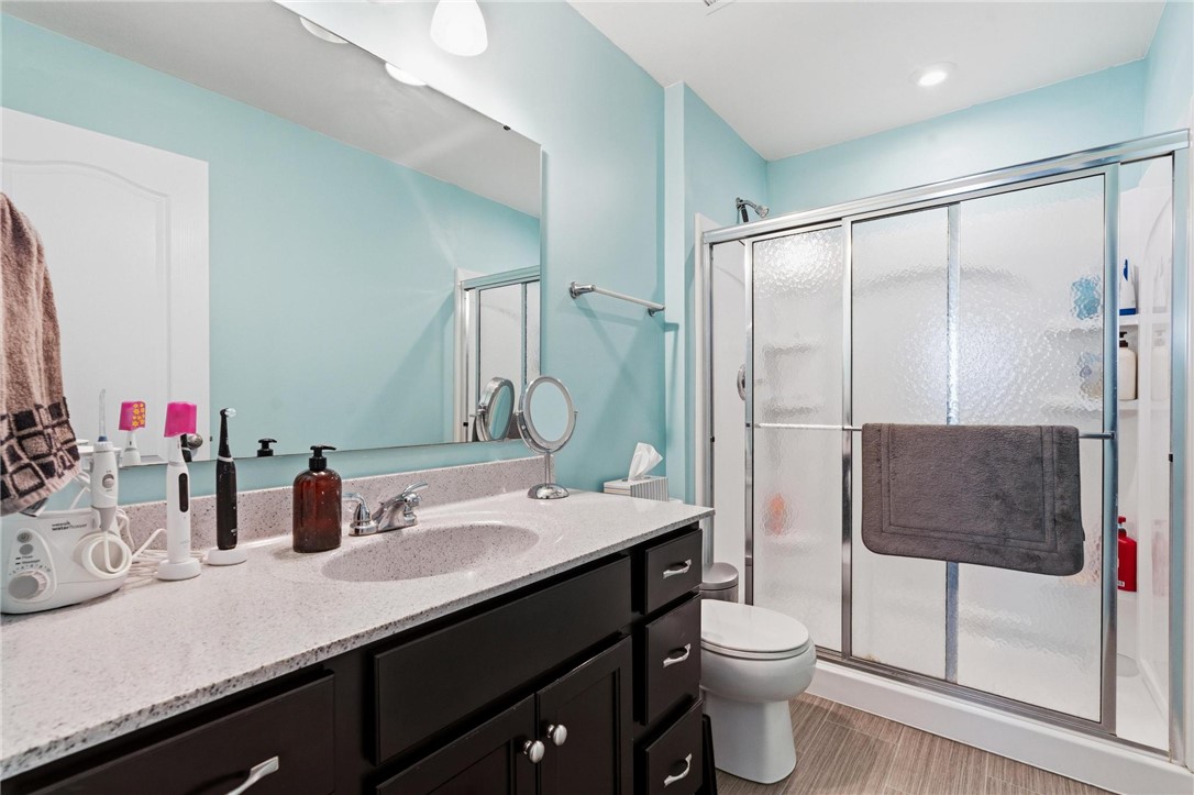 141 Old Pond Road Springboro, OH 45066 - Photo 18 of 20 Primary bath features a walk in shower, a vanity with a sink, and stylish tile flooring.