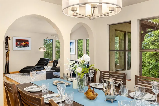 a view of a dining room with furniture a chandelier and wooden floor
