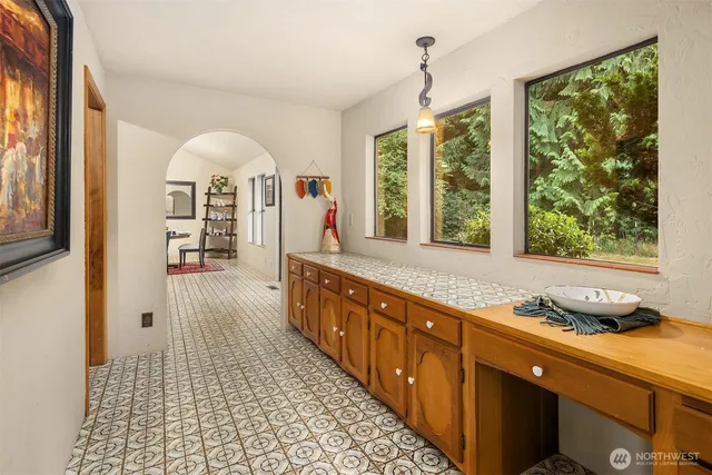 a large kitchen with granite countertop a stove a sink and a large window