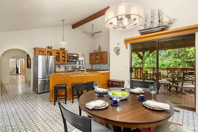 a dining room with furniture a chandelier and wooden floor