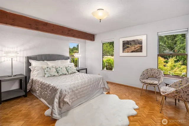 a bedroom with a bed chair and window