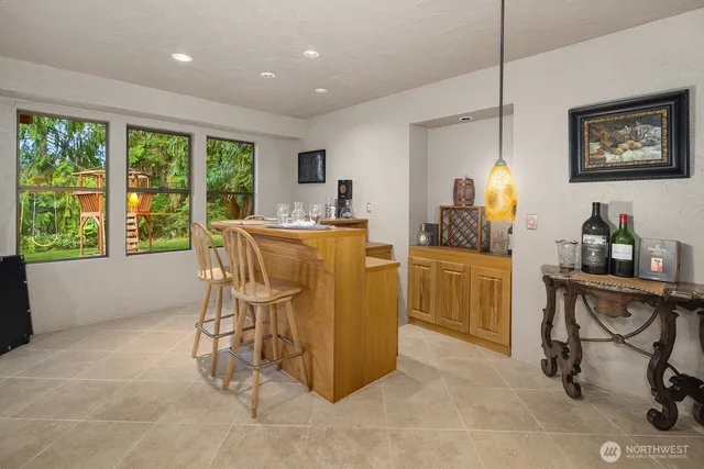 a living room with furniture and large windows