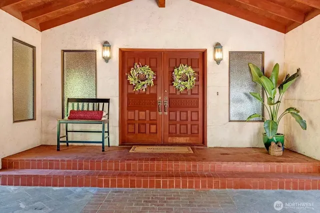 a view of front door with potted plants