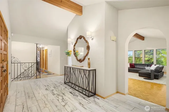 a view of a hallway with wooden floor and furniture