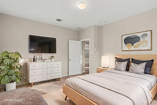 a bedroom with a bed and a flat screen tv