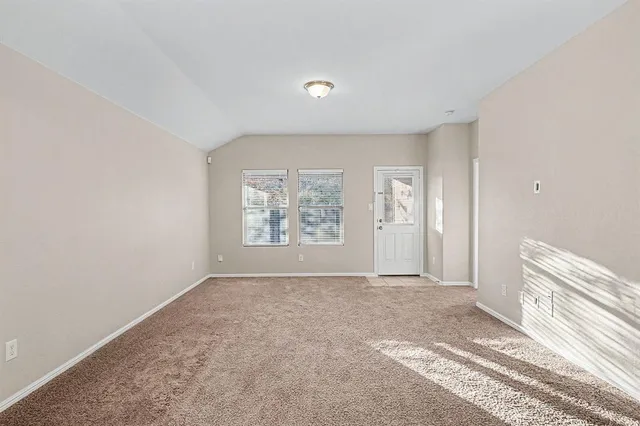 a view of a big room with windows and closet