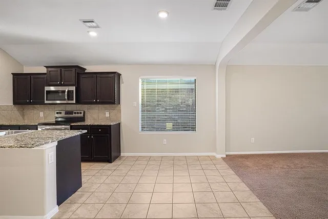 a kitchen with a stove a sink and a microwave