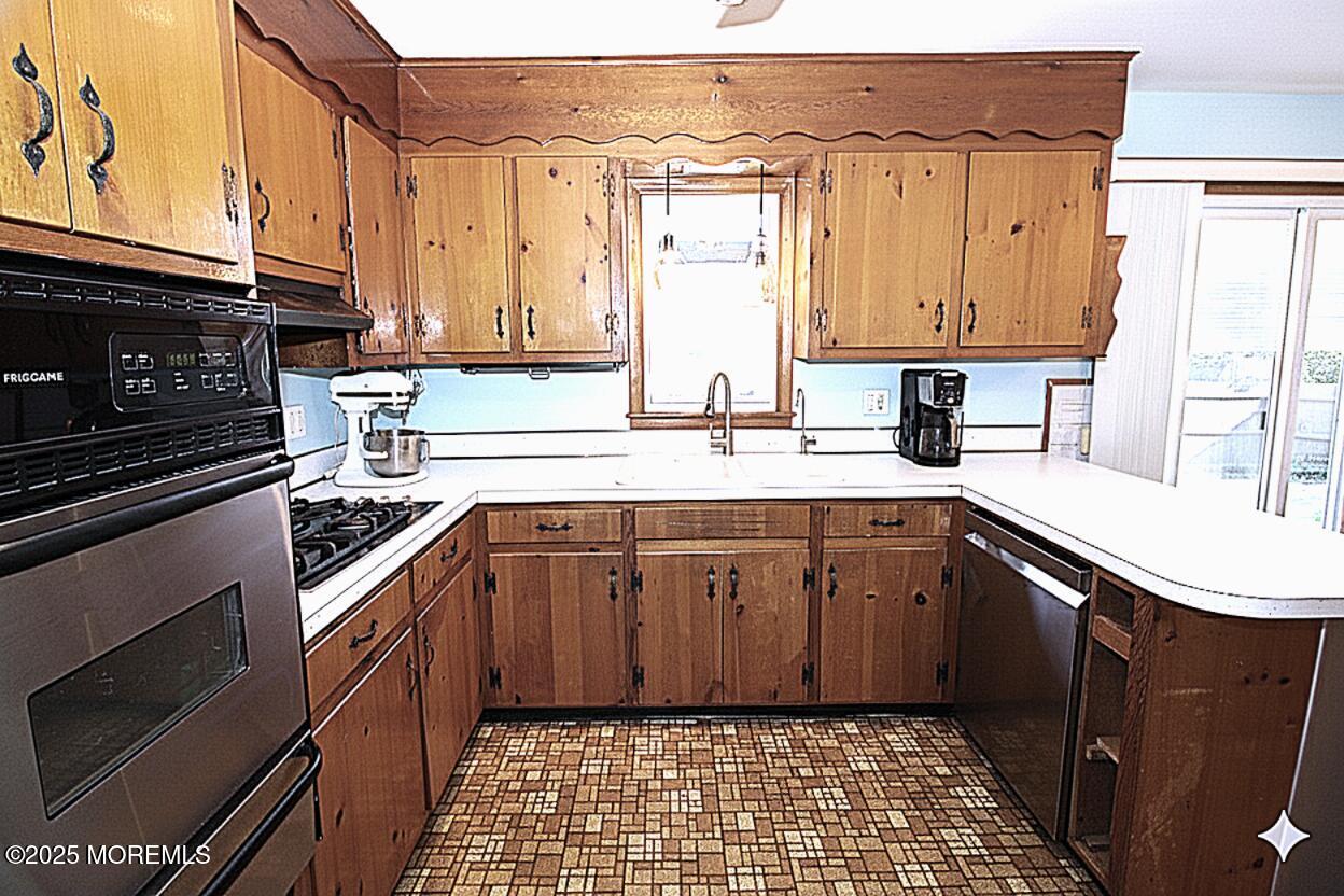 60 Shell Street Beachwood, NJ 08722 - Photo 10 of 24 a kitchen with a sink stove and cabinets