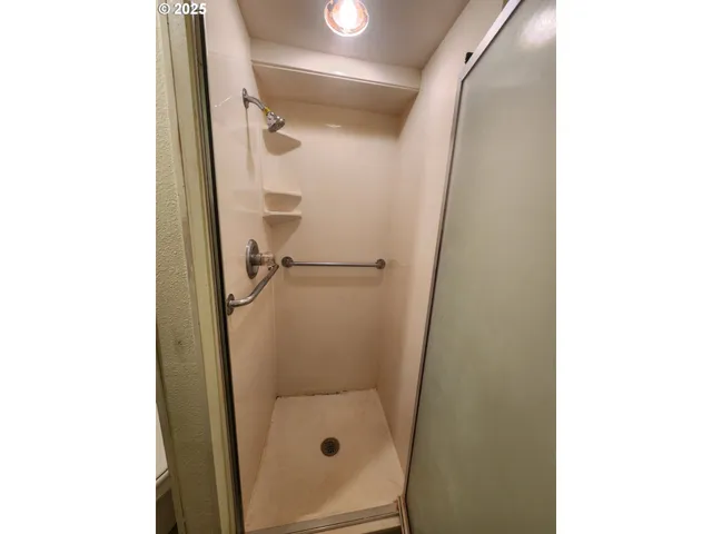 a bathroom with a glass shower door