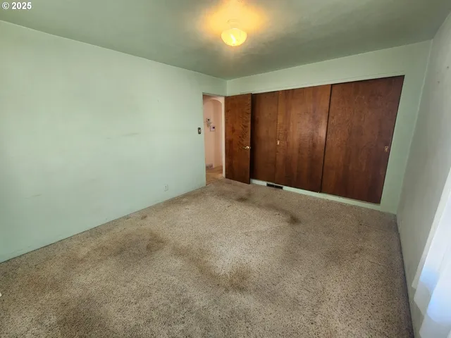an empty room with closet area