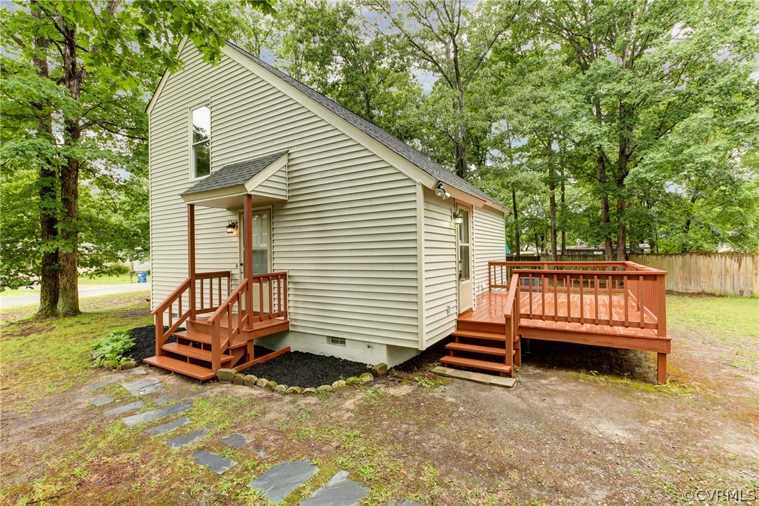 a view of backyard with a deck
