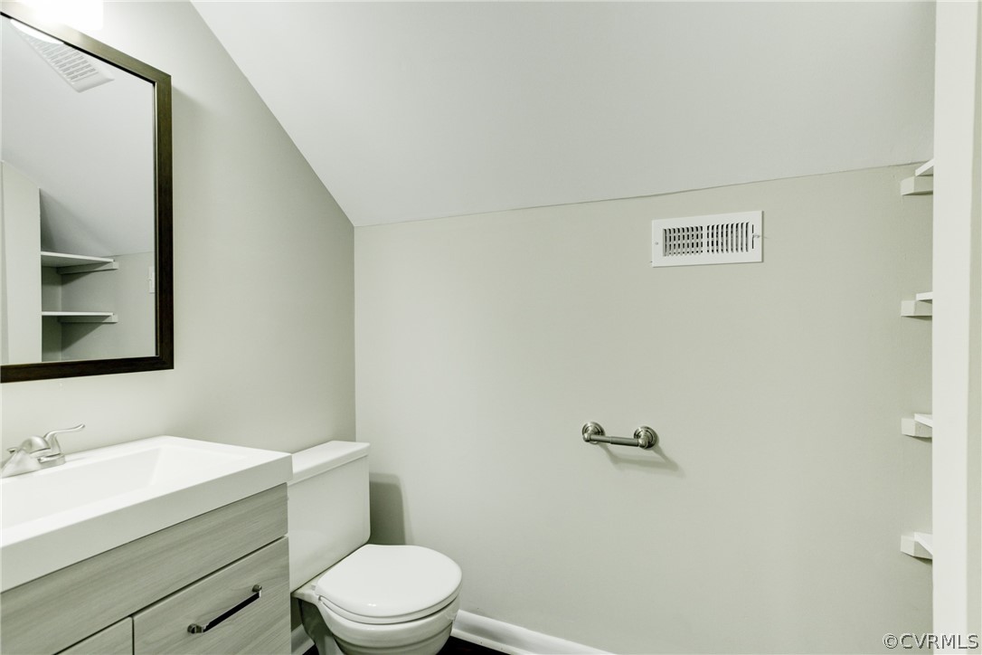 15820 Tri Gate Road Chester, VA 23831 - Photo 17 of 29 a bathroom with a granite countertop toilet sink mirror and vanity