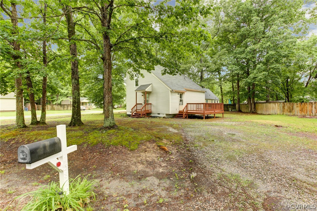 15820 Tri Gate Road Chester, VA 23831 - Photo 23 of 29 a front view of a house with a yard table and chairs