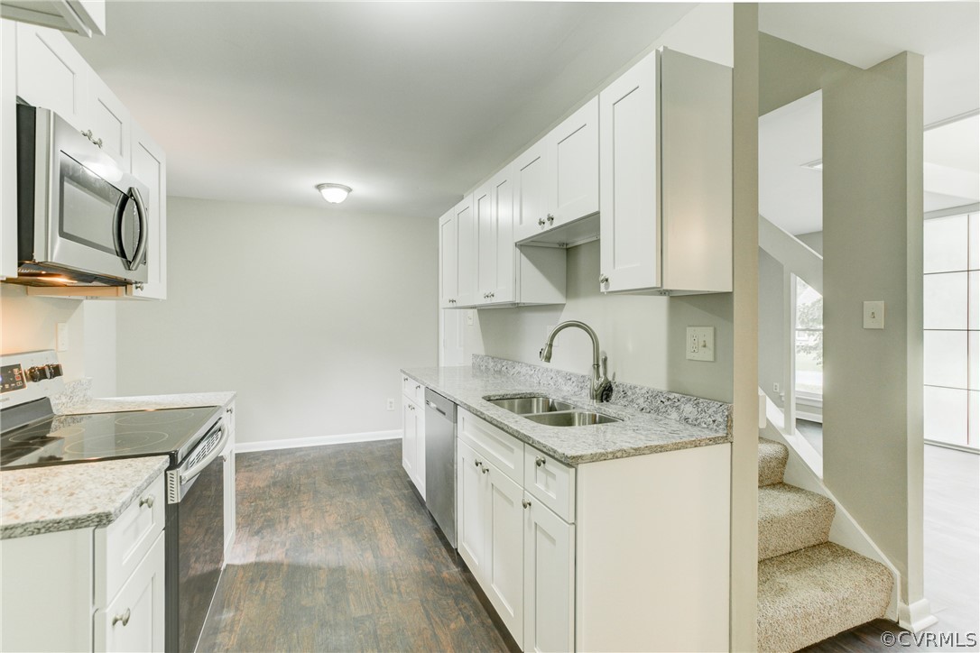 15820 Tri Gate Road Chester, VA 23831 - Photo 5 of 29 a kitchen with stainless steel appliances granite countertop a sink stove and cabinets