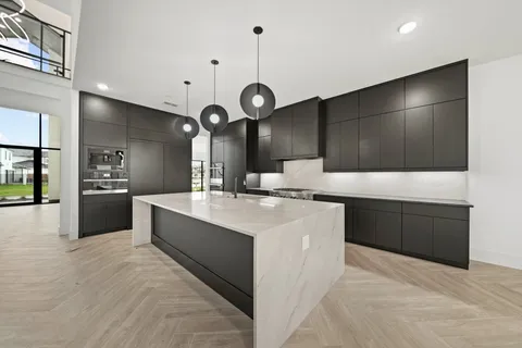 a large kitchen with kitchen island a sink stainless steel appliances and cabinets