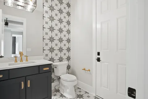 a bathroom with a sink toilet vanity and shower